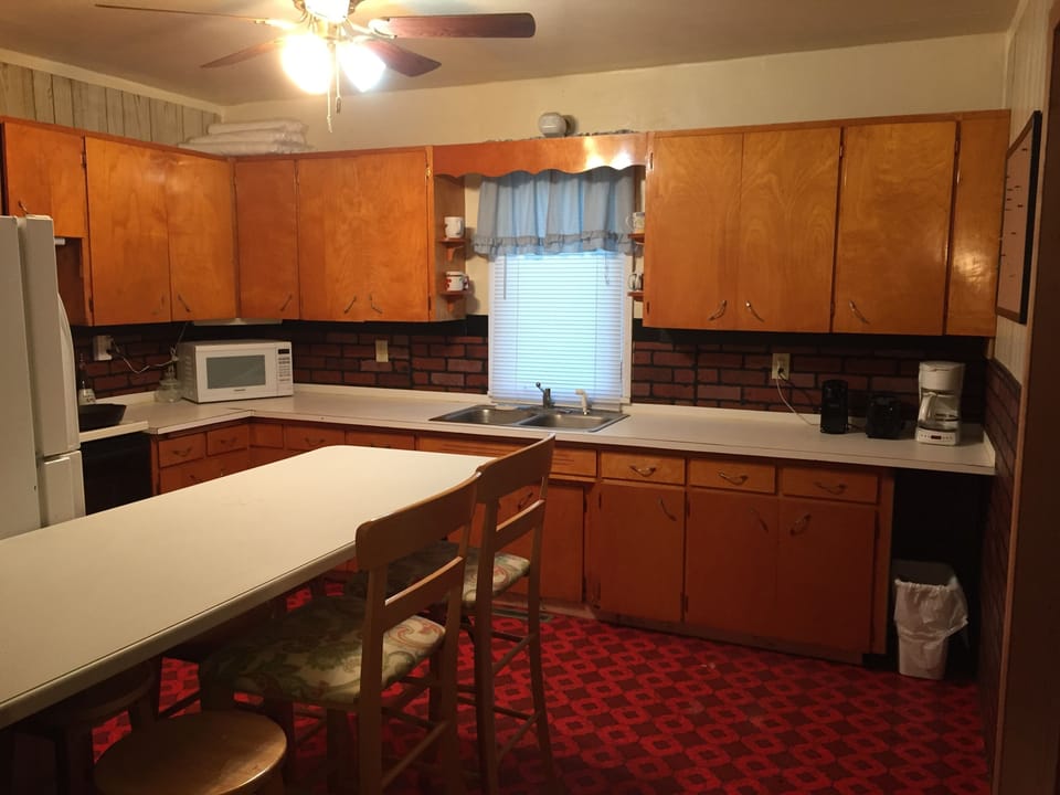 Kitchen stocked with appliances and dinnerware