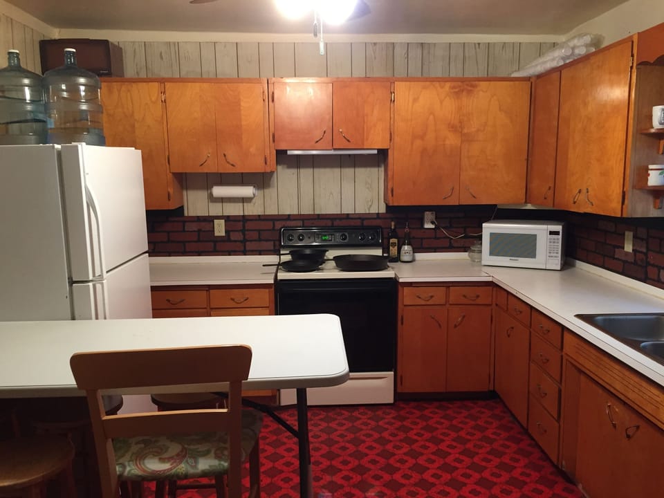 Kitchen with full size refrigerator with freezer.