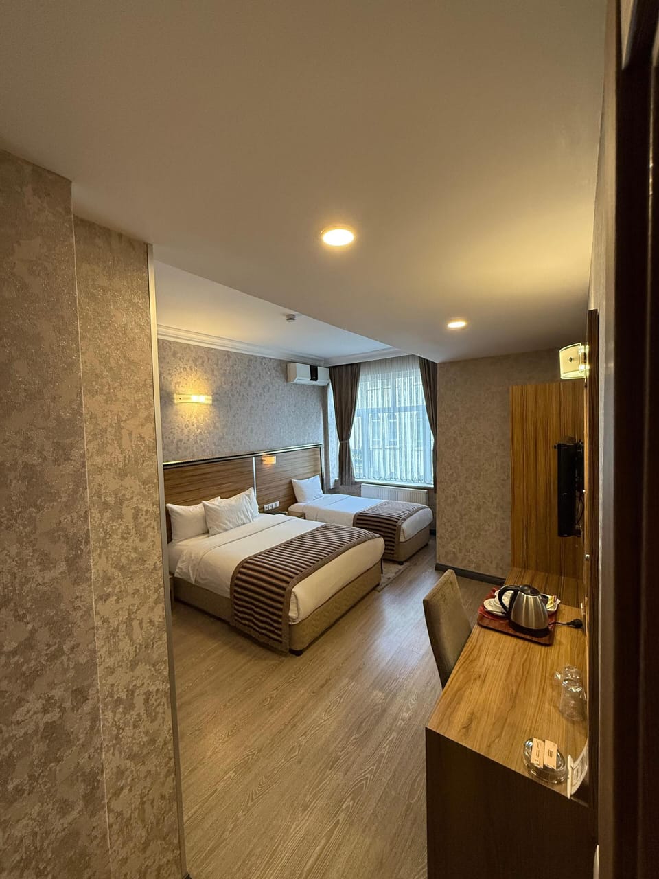Family Triple Room | Free minibar items, in-room safe, desk, laptop workspace