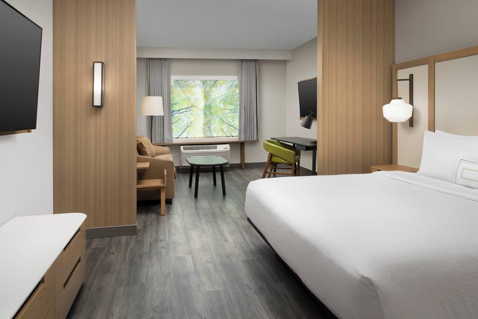 Premium bedding, desk, laptop workspace, blackout drapes
