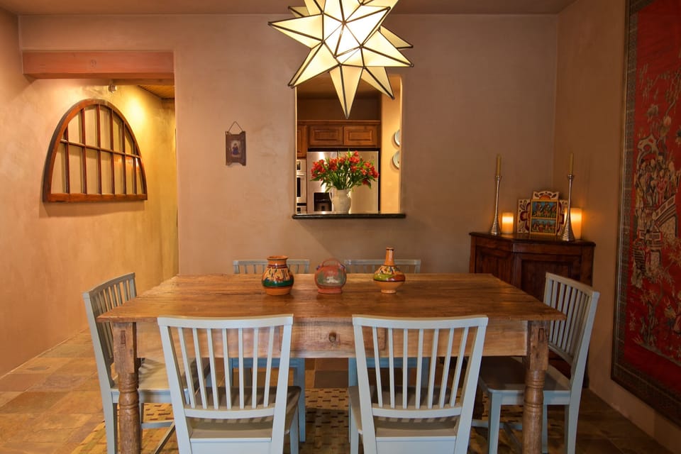 The open living area includes an antique Spanish colonial dining table. 