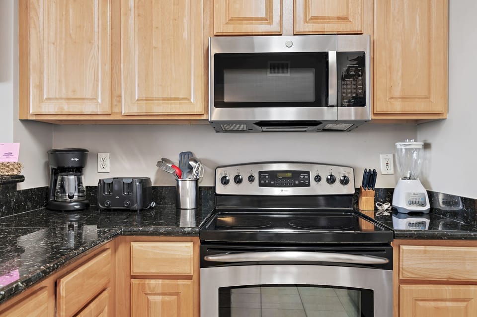 Upgraded kitchen features stainless steel appliances and granite countertops.