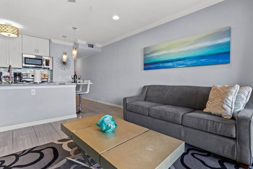 Living Room: Stylish elegance meets comfort with vibrant art and modern accents!