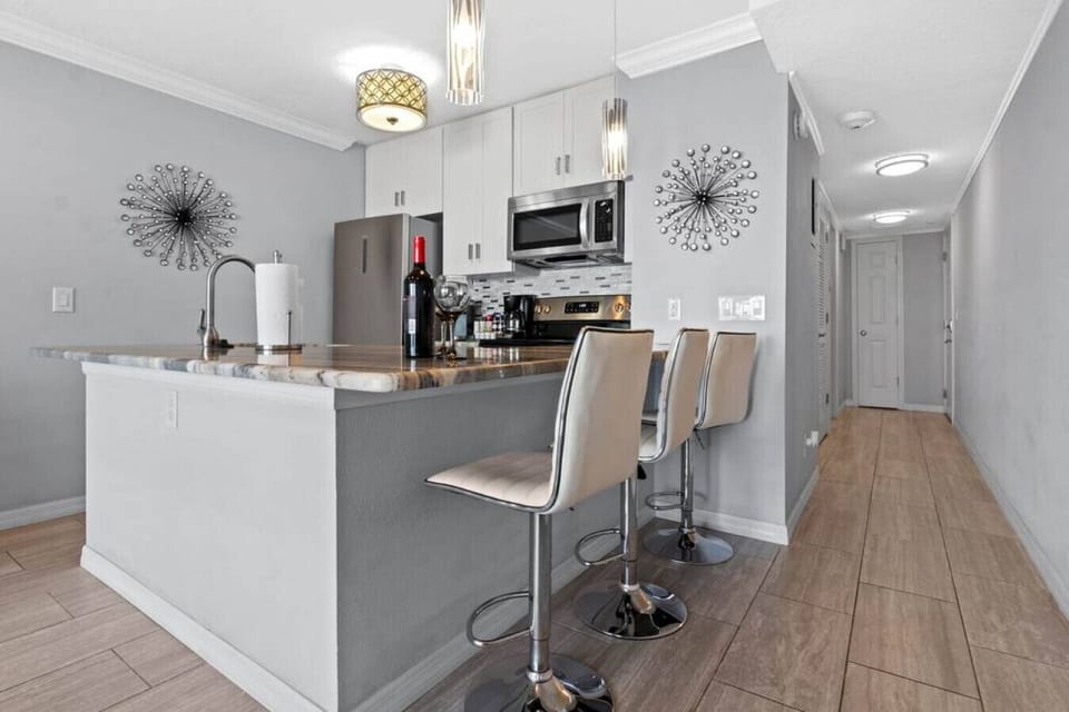 Kitchen: Stylish bar seating and modern appliances await your culinary adventures!