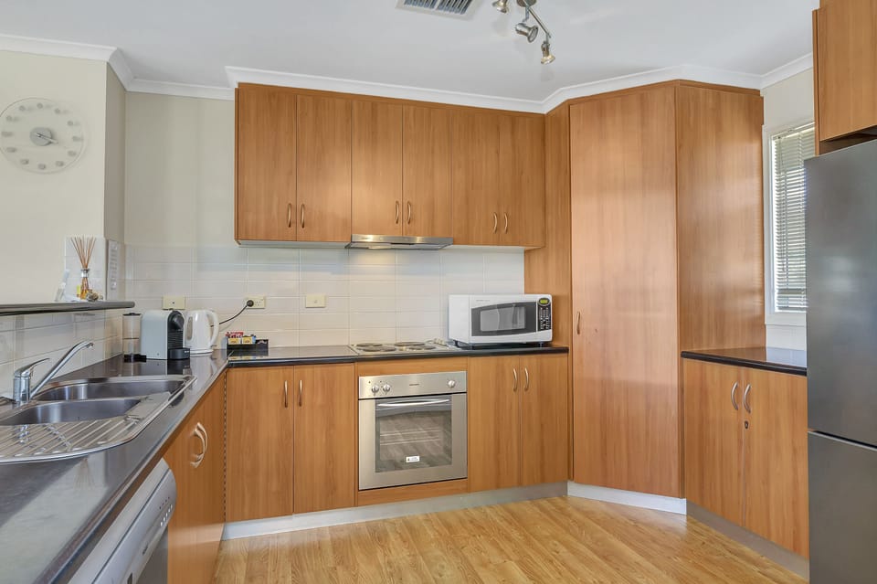 Green Reef Beach House | Private kitchen | Full-size fridge, microwave, oven, stovetop