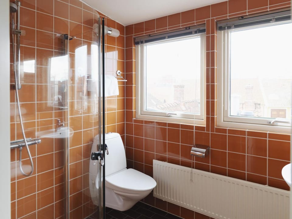 Shower, designer toiletries, hair dryer, towels
