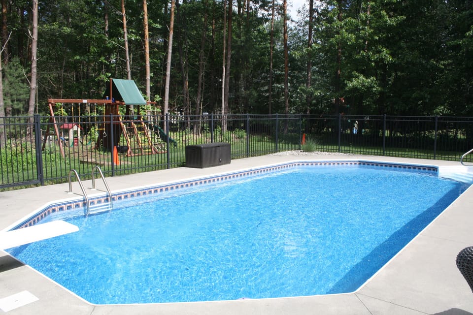 In-ground pool, tons of pool toys, backyard playground, and horseshoe pit