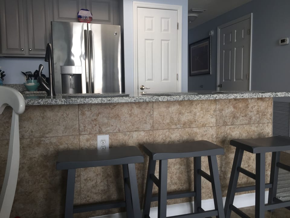 3 stools in front of kitchen counter where new granite was just installed
