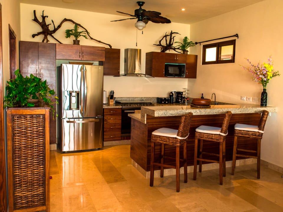 Kitchen with oversized french door fridge, 6 burner stove, dishwasher, bar sink.