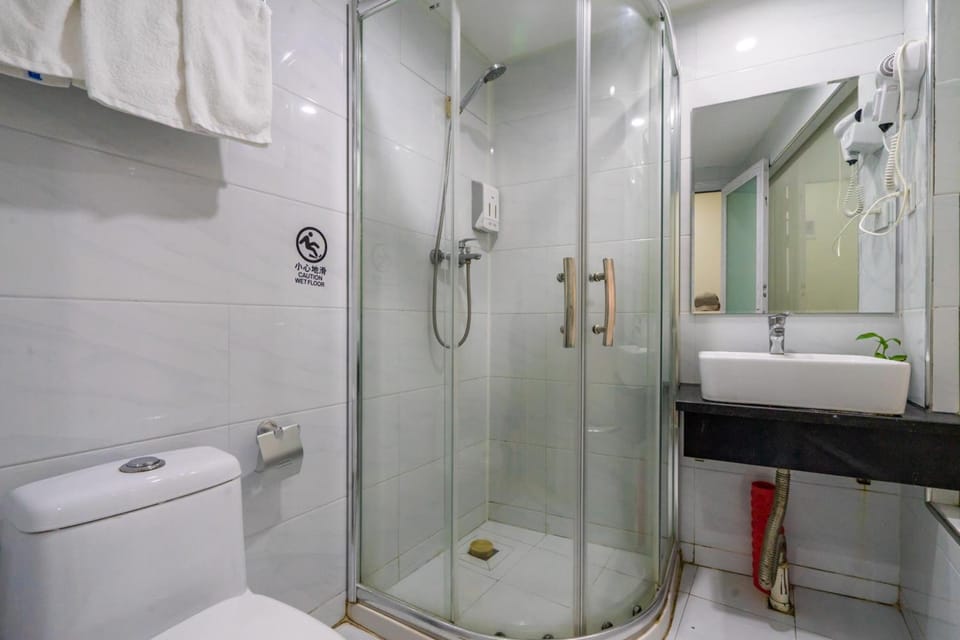 Shower, hair dryer, slippers, towels