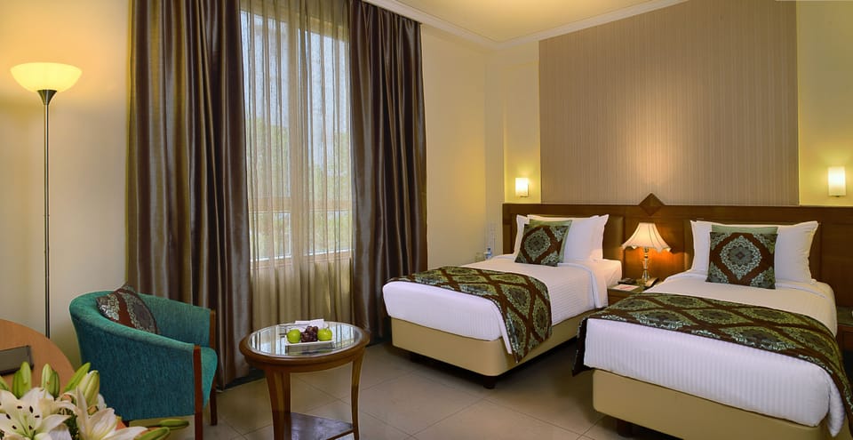 Deluxe Room | Premium bedding, minibar, in-room safe, individually decorated