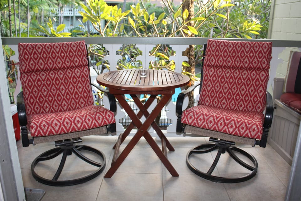 Swivel rockers dappled by sun shining thru the foliage of south-facing lanai
