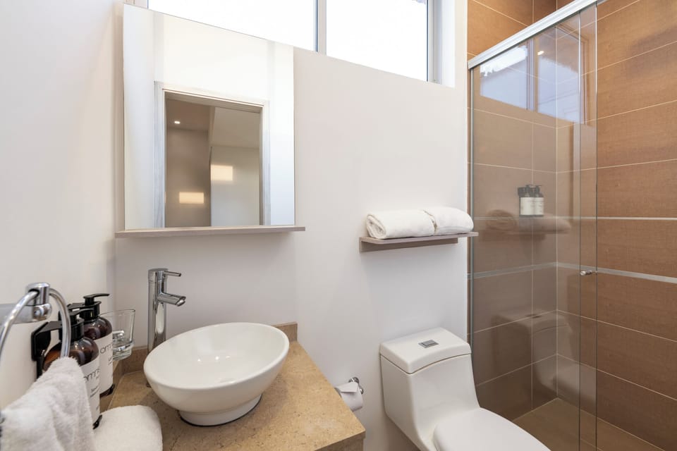 Shower, rainfall showerhead, hair dryer, towels