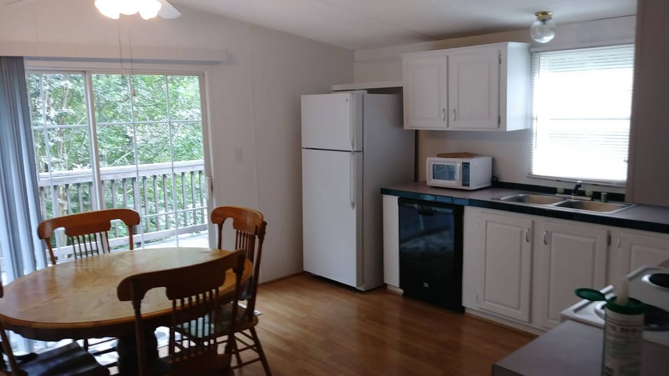 Fully furnished kitchen.  Sliding glass doors lead to the deck.