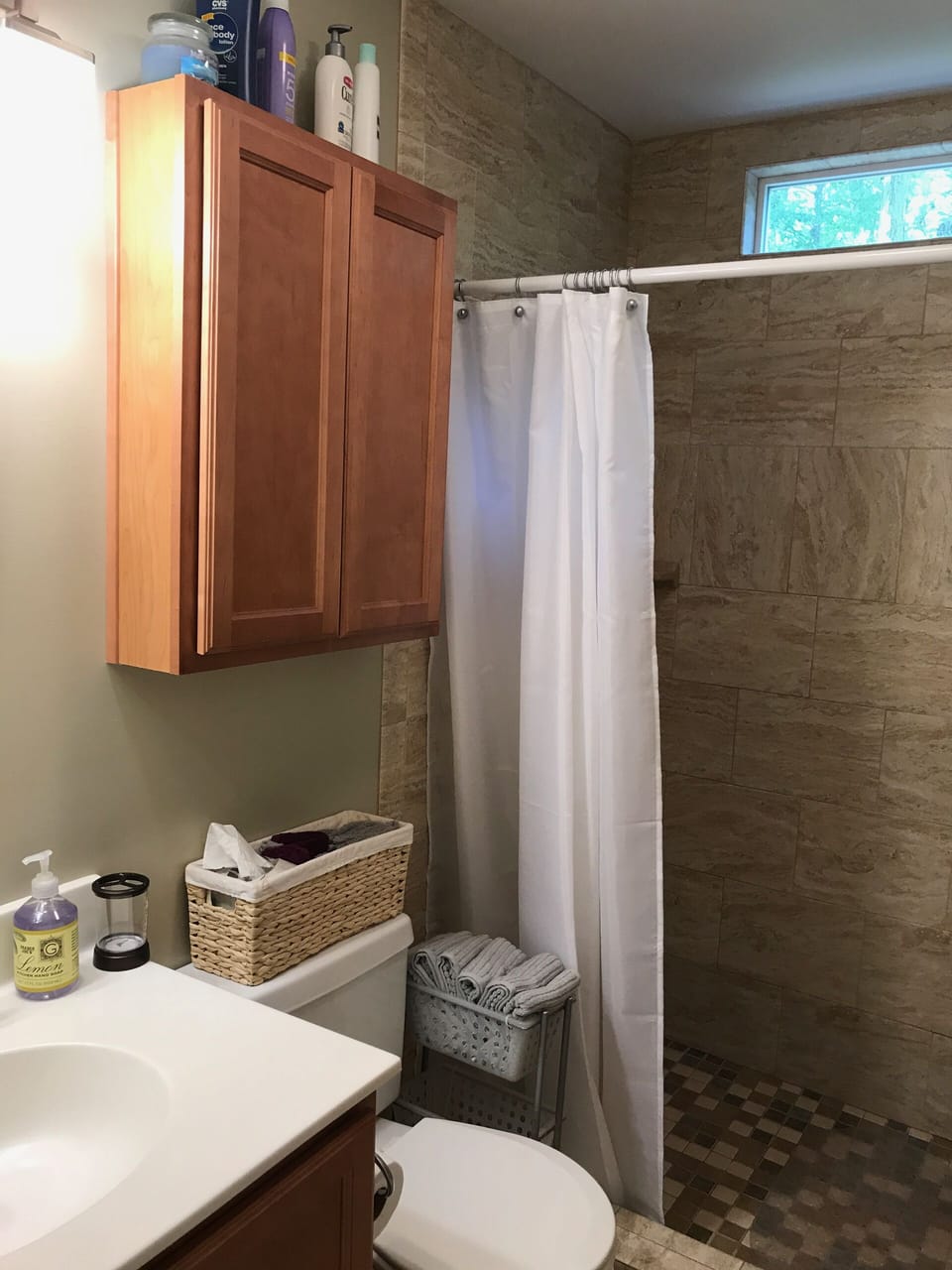Walk in shower with natural light and view of the tree tops.
