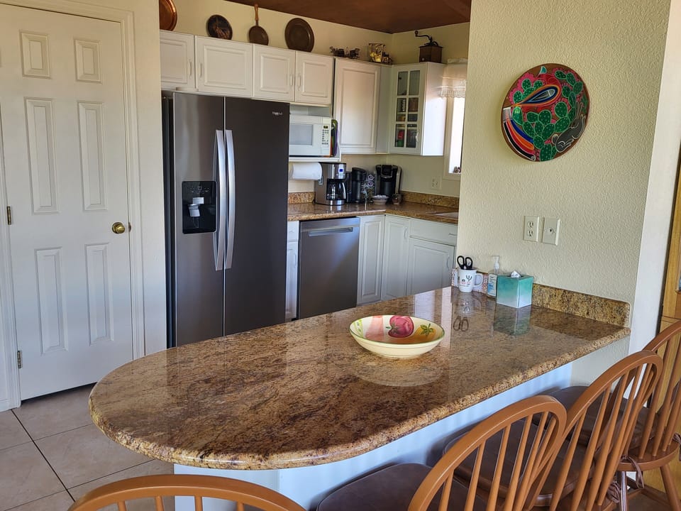 Fully equipped kitchen supplied with coffee, sugar, creamers, spices, olive oil
