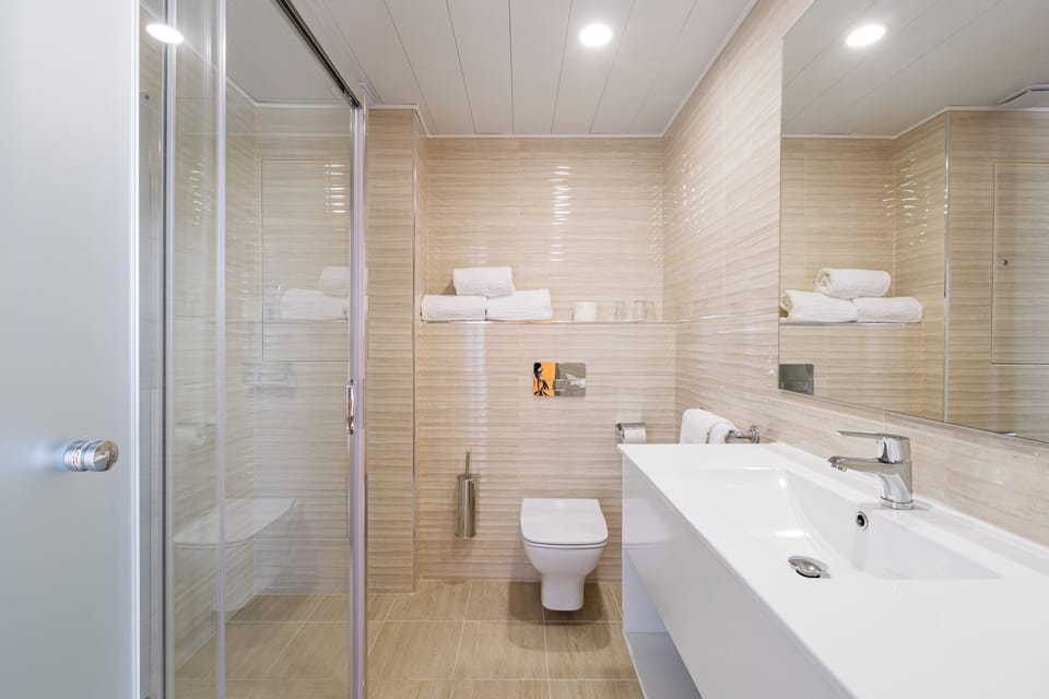 Shower, rainfall showerhead, designer toiletries, hair dryer