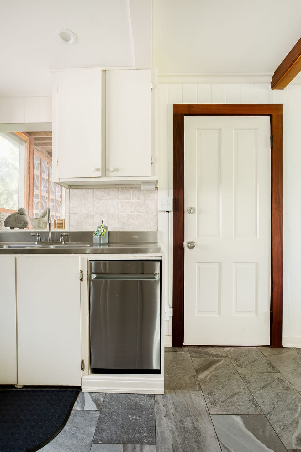 Door towards "mud room" where dryer is kept and exit to recycling and washer