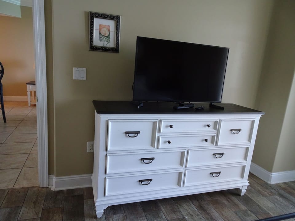 Main bedroom with king bed and balcony access