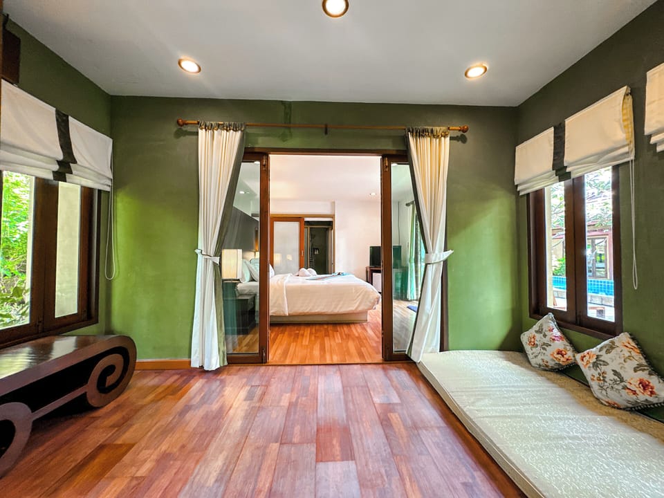 Family Suite, Pool View | Living area | 32-inch LCD TV with cable channels, TV