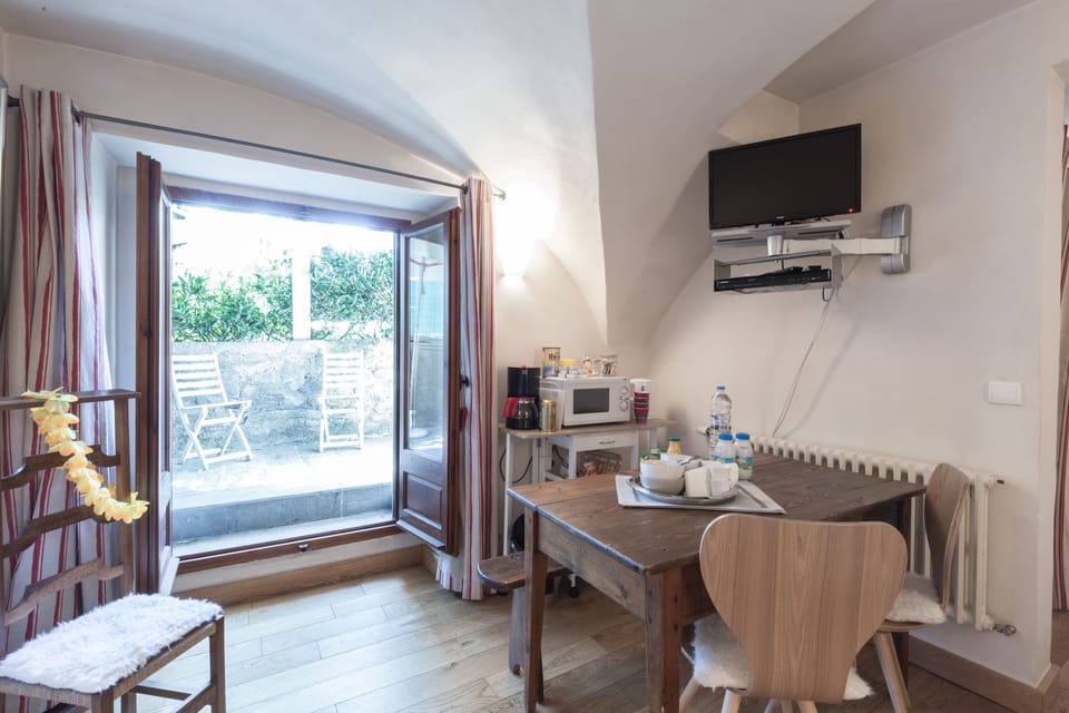 Family Quadruple Room | Living area | 60-cm flat-screen TV with cable channels, TV, DVD player