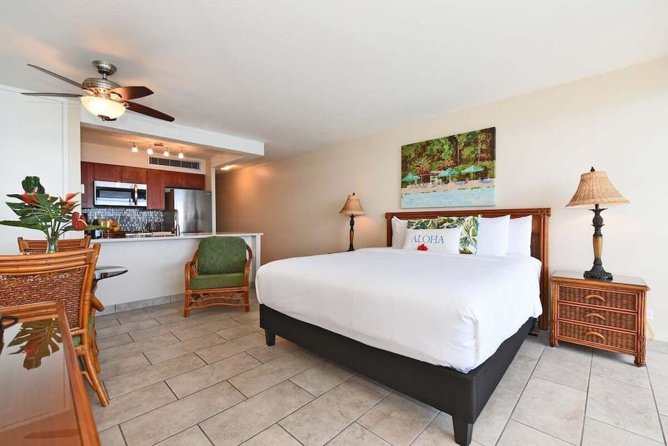 Enjoy comfort and style in this open bedroom featuring coastal décor and natural light
