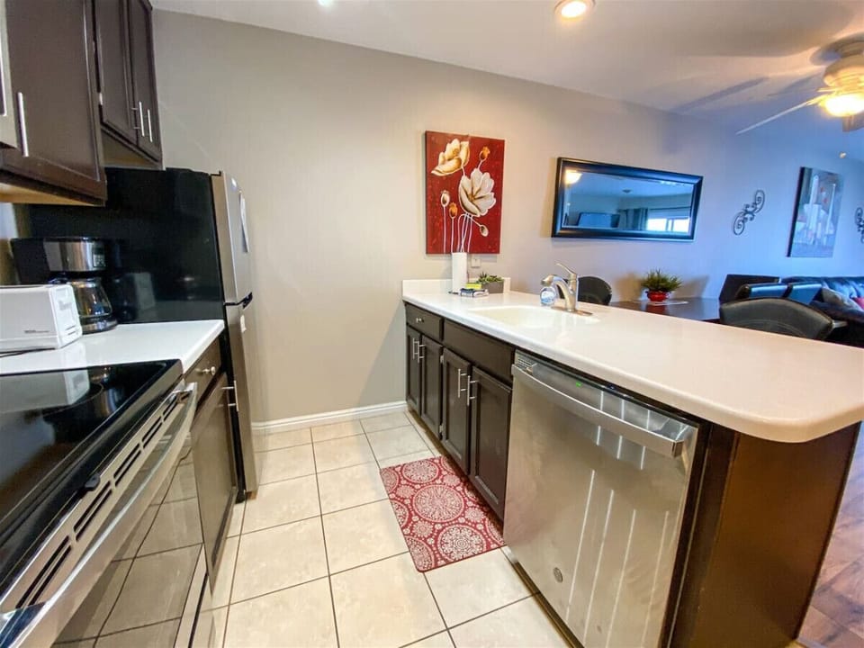 Modern kitchen with sleek appliances and cozy touches, perfect for preparing meals and gathering together