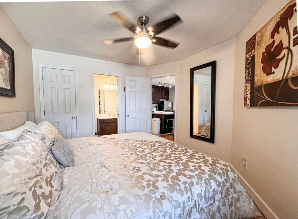 Cozy bedroom with elegant décor, plush bedding, and easy access to the kitchen and bath