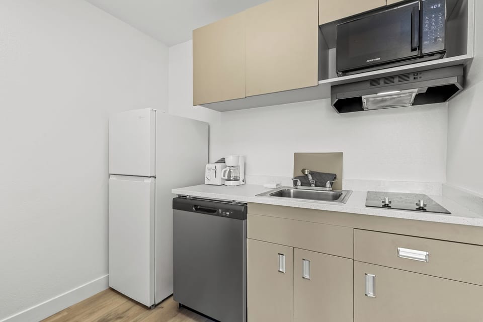 Suite, 1 King Bed, Non Smoking | Private kitchen | Full-size fridge, microwave, stovetop, cookware/dishes/utensils