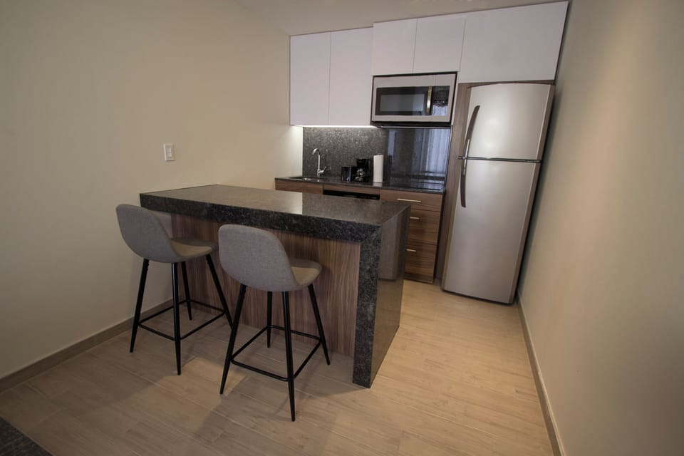 Suite, 1 King Bed | Private kitchen | Full-size fridge, microwave, dishwasher, coffee/tea maker