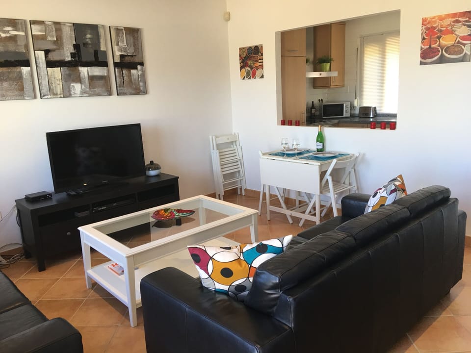 Lounge with two 3 seater sofa's, dining table for 4, flat screen TV, air con.