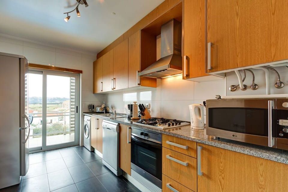 Fully equipped kitchen with dishwasher, large fridge-freezer, washer-dryer and microwave.