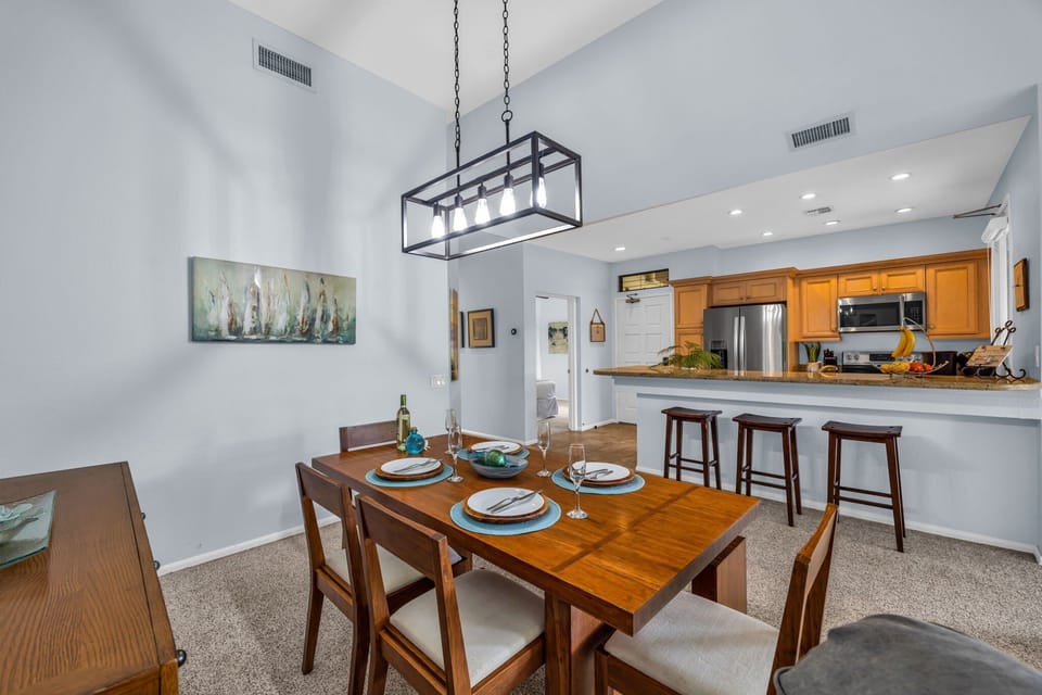 Enjoy home-cooked meals at the bright dining table adjacent to the kitchen