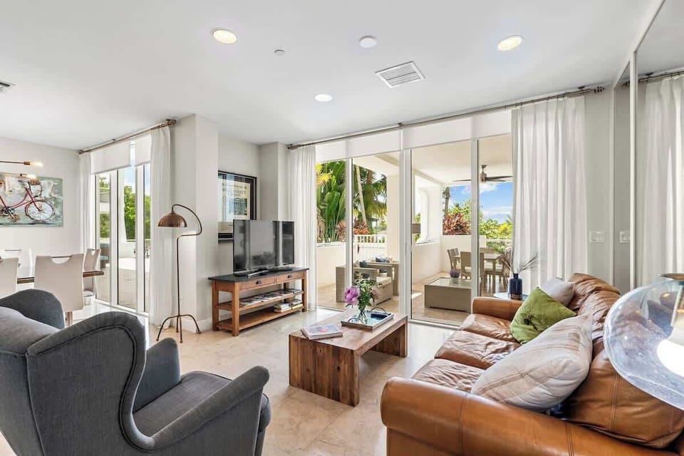 A spacious and comfortable living room with direct access to the outside patio