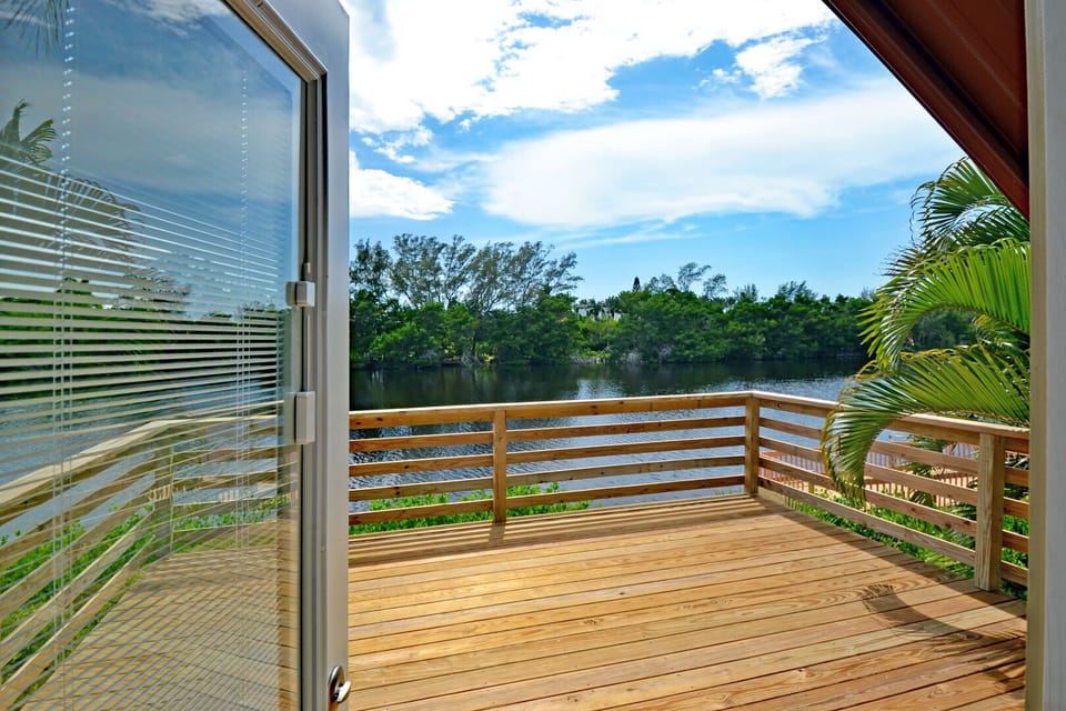 Open door leading to the lakefront balcony with water views beyond