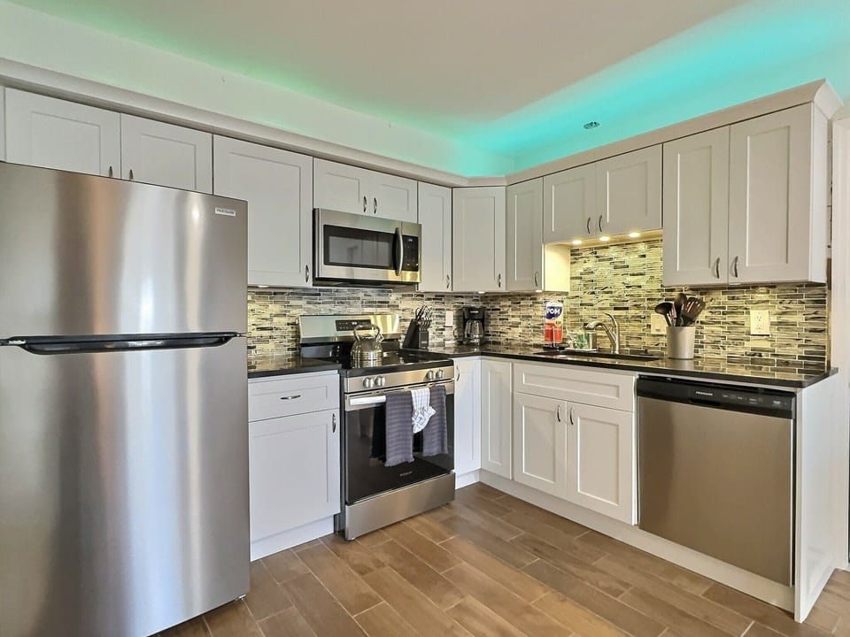 Fully equipped kitchen with stainless steel appliances and cabinetry