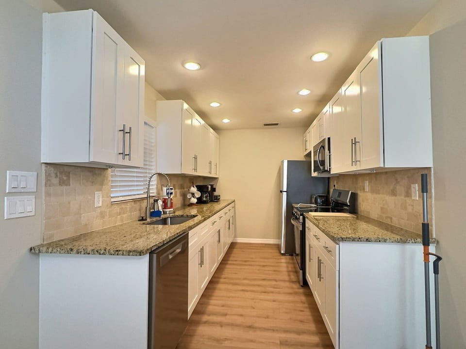 This spacious kitchen offers ample room for cooking and features modern appliances and plenty of counter space.