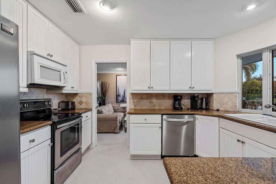 The kitchen is next to the TV lounge area