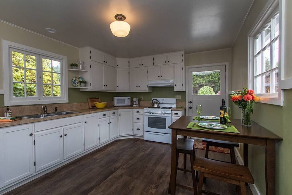 Cooking is delightful in this fully stocked kitchen with cafe style dining table.