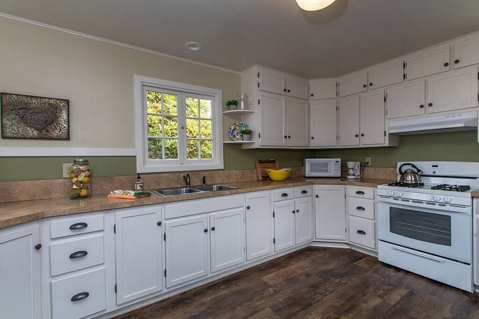 Plenty of cabinet space for stocking delicious groceries in this cozy kitchen.