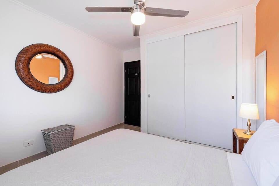 Cozy bedroom featuring an inside closet and air conditioning, perfect for storing your belongings and enjoying a restful stay in Tamarindo Beach.