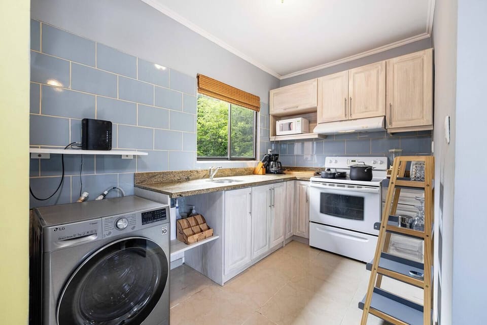 Fully equipped kitchen with modern appliances and an in-unit washer, making it easy to prepare meals and do laundry during your Tamarindo vacation rental stay.
