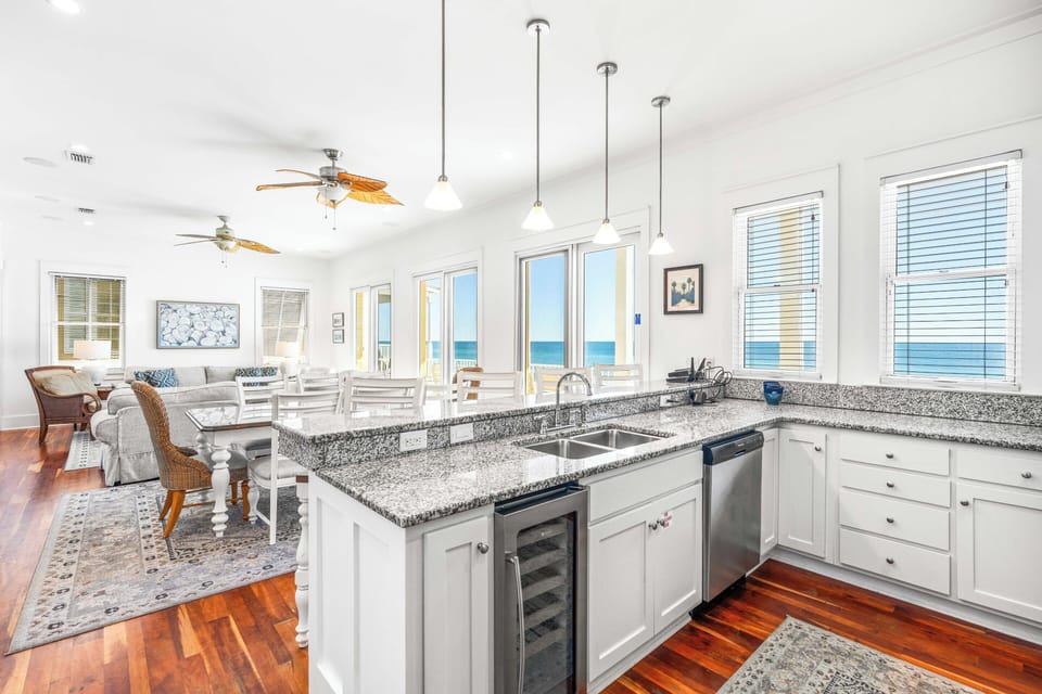 Open kitchen on the 2nd floor level great room with stainless steel double sinks, wine cooler, dishwasher & granite countertops.
