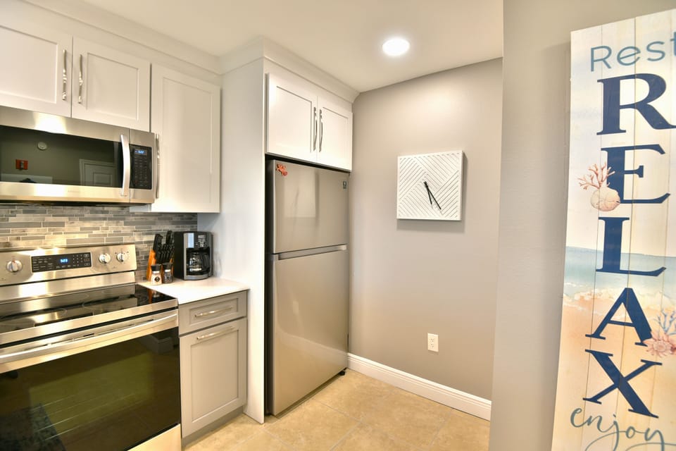 Kitchen with stainless appliances and coastal décor