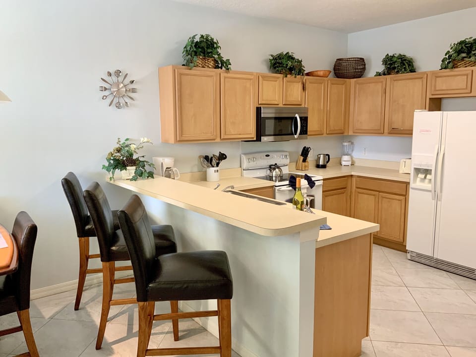Kitchen with breakfast counter and seating area for up to 8 people.