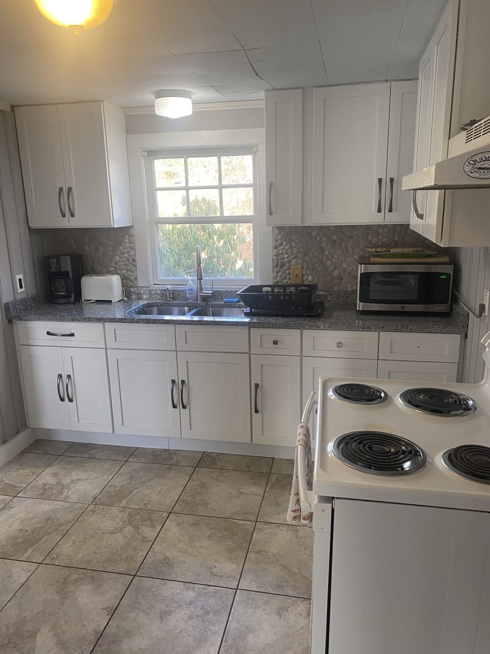 Granite Countertop Kitchen with Microwave, stove, & fridge