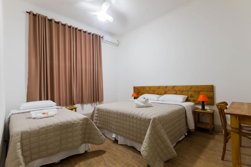 Luxury Triple Room | Minibar, in-room safe, desk, blackout drapes