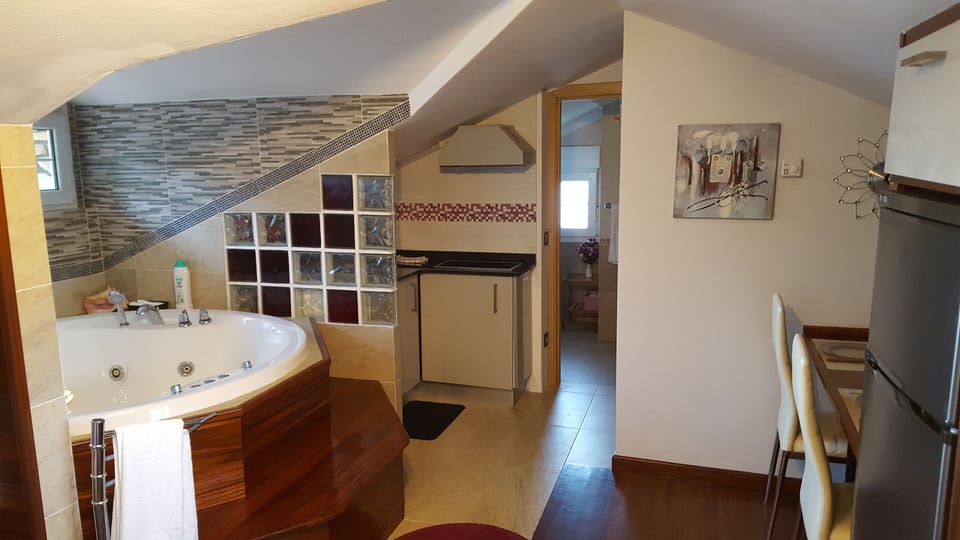 Jacuzzi, kitchen and entrance to the toilet.