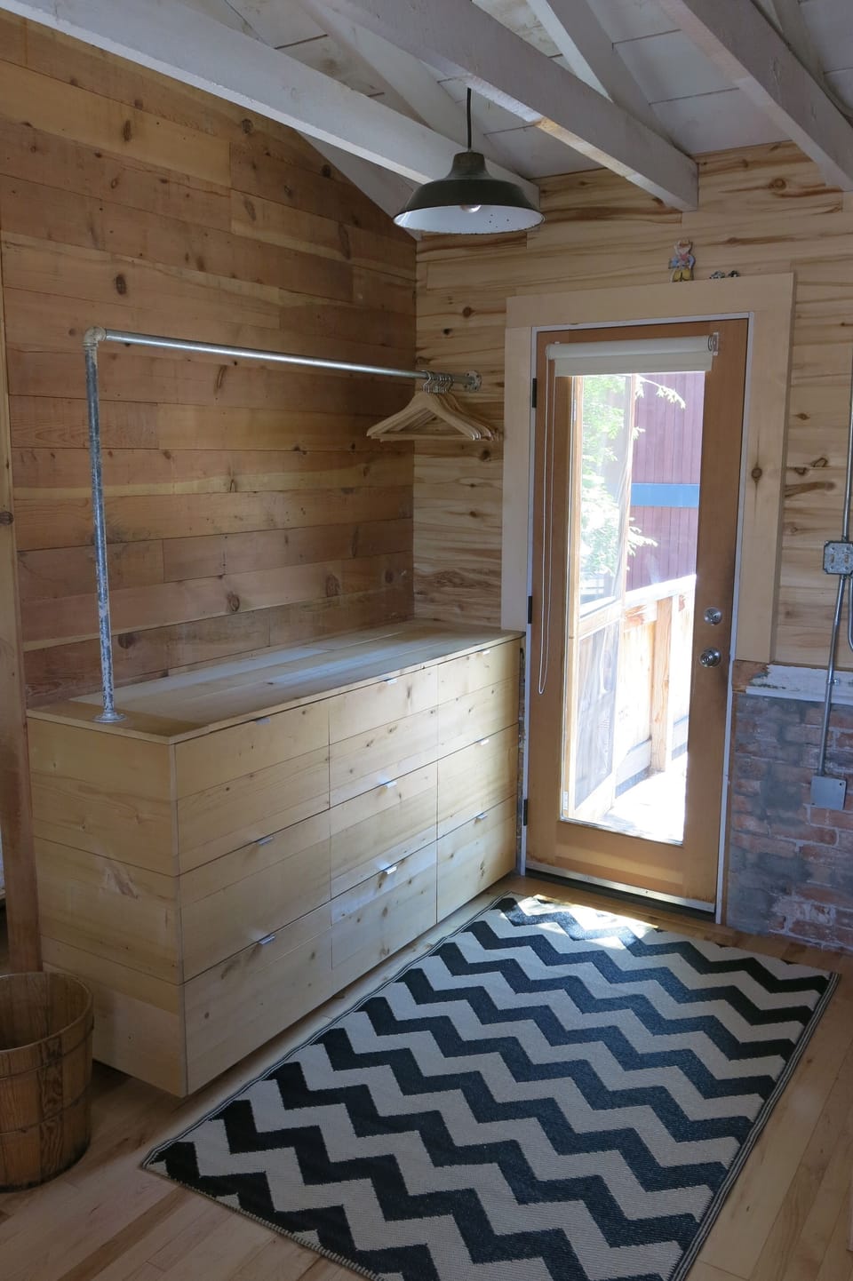 Just at the entry, a custom built cabinet provides storage for all essentials.