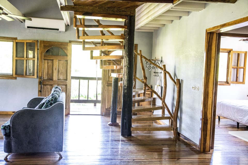 Spiral staircase leading up to two bedrooms and one bathroom